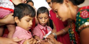 A health worker marks a boy’s finger with ink, to show that he has been vaccinated, at Dr. C.G. Government School in the Sargar neighbourhood of the city of Ahmedabad in Gujarat State, during SIA campaign against measles. About 600 children, aged 9 months to 10 years of age, were vaccinated at the school. Four vaccination teams – each comprised of a vaccinator, a community volunteer, an anganwadi worker, and a schoolteacher or community worker; and overseen by a supervisor – were deployed from the Sardar Nagar health centre to accommodate the higher-than-anticipated turnout.In mid-October 2012 in India, a series of Supplementary Immunization Activities (SIAs) that began in 2010 is aiming to vaccinate all children aged 9 months to 10 years – some 134 million children – in 14 states against measles by the end of June 2013. An estimated 90,000 Indian children die from the disease each year, accounting for 67 per cent of all measles deaths worldwide. Although measles vaccinations for all children under age 1 are part of India’s routine immunization programmes, more than 20 per cent of infants in the targeted 14 states, including Gujarat and Bihar, are not vaccinated against measles. Government-led SIA campaigns in these states are vaccinating children at schools, ‘anganwadis’ (village-level health centres), urban health centres and other fixed locations. And, more than 100 mobile health units are being deployed to reach children in migrant families. Children under age 5 are also receiving vitamin A, to help boost their immunity. SIAs are part of a multi-partner effort by the Government and the Measles & Rubella Initiative, a global partnership led by the American Red Cross, the United Nations Foundation, the United States Centers for Disease Control and Prevention (CDC), the World Health Organization (WHO) and UNICEF. Worldwide, measles remains a leading cause of death among young children: In 2010, an estimated 139,300 people – mainly children und